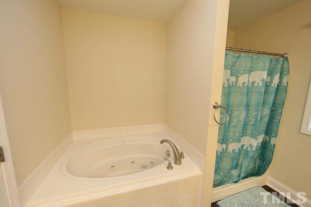 4609 Pearl Road Raleigh, NC 27610 - Photo 7 of 12 a bathroom with a tub and shower