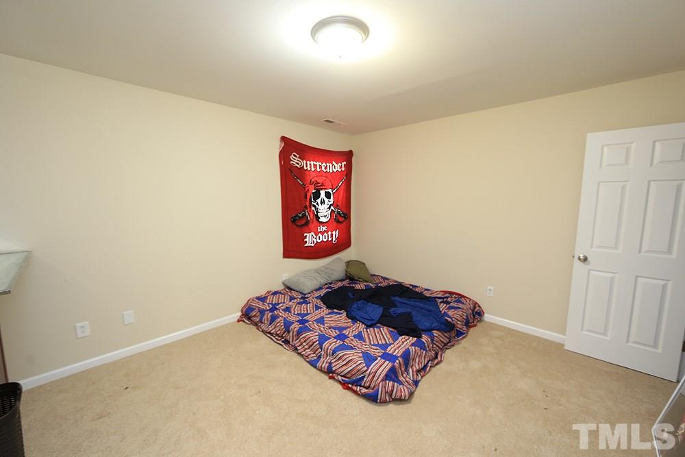 4609 Pearl Road Raleigh, NC 27610 - Photo 9 of 12 a bed room with a bed and a wall painting