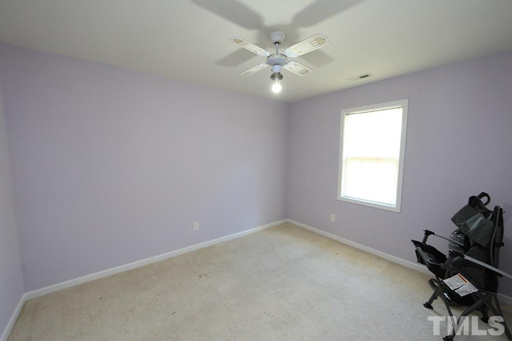 4609 Pearl Road Raleigh, NC 27610 - Photo 10 of 12 an empty room with windows and fan
