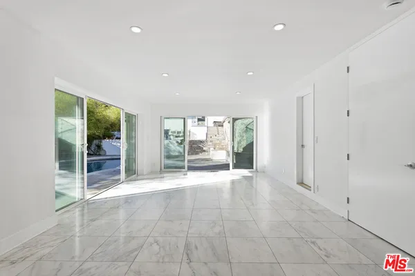 a view of an empty room with a window