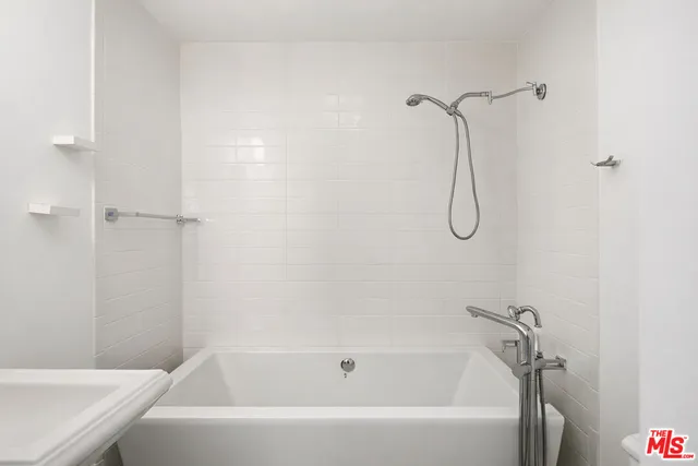 a view of wooden floor in an empty room with a window