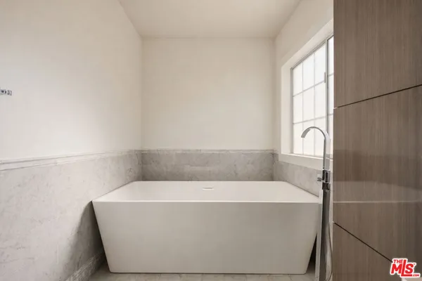 a bathroom with a bathtub and shower
