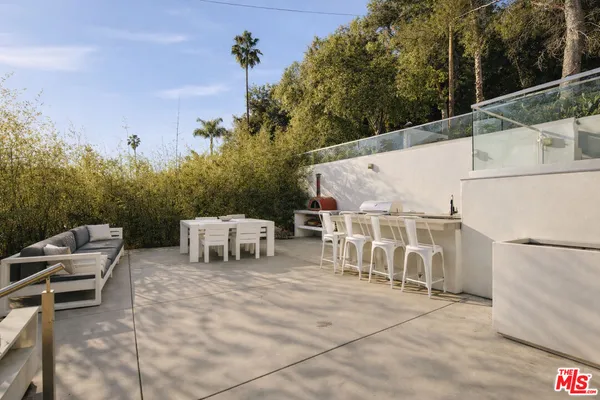 a view of a patio with table and chairs with wooden floor and fence