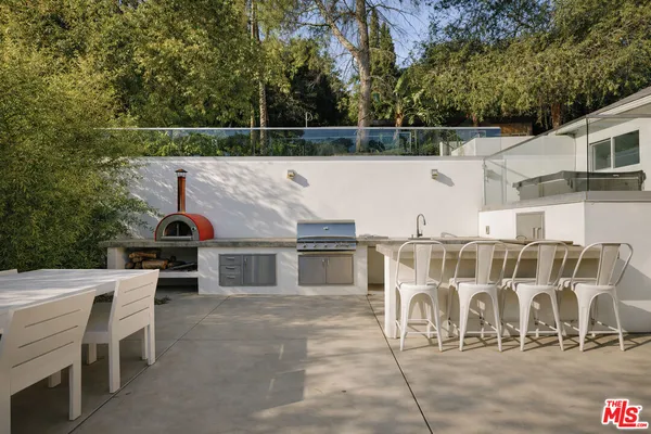 a view of a terrace with chairs and a fire pit