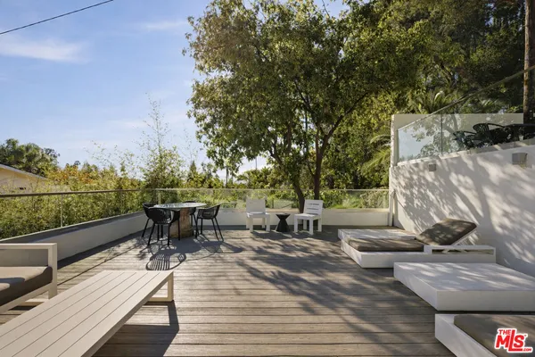 a view of an empty room with window and a kitchen