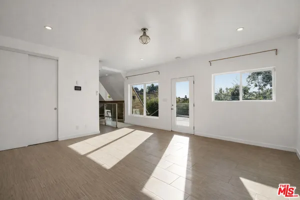 a view of entryway and hall with wooden floor