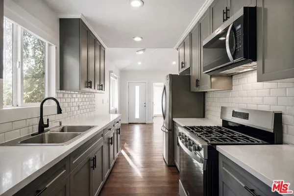 a view of wooden floor in an empty room with a window