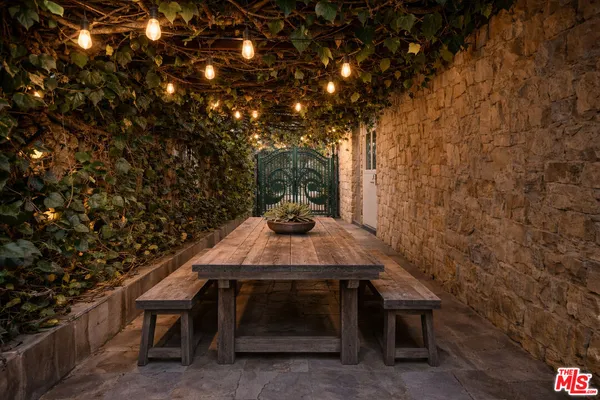 a backyard of a house with table and chairs