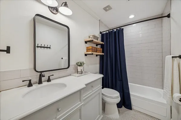 an aerial view of residential houses with outdoor space and trees