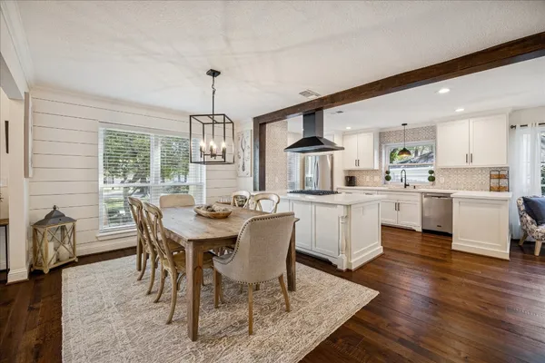 a kitchen with stainless steel appliances a stove sink and cabinets
