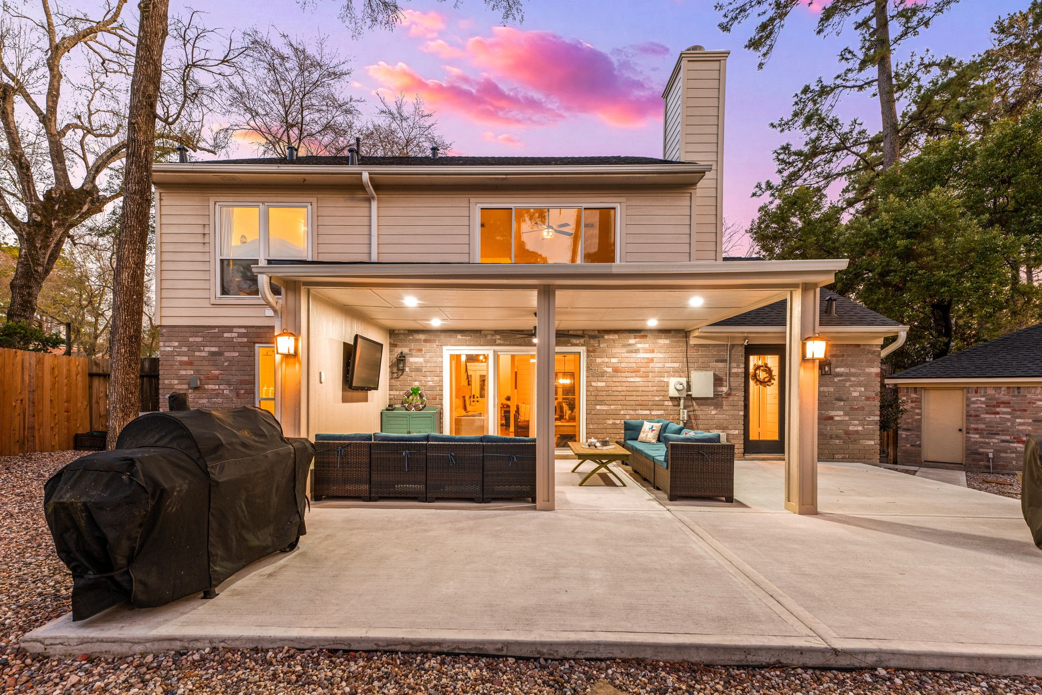57 Fire Flicker Place Spring, TX 77381 - Photo 6 of 11 The home is surrounded by mature trees and has a welcoming, warm exterior.