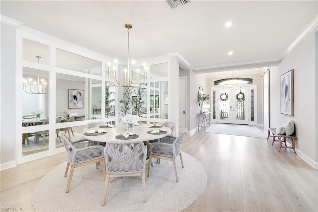 11200 Canal Grande Drive Fort Myers, FL 33913 - Photo 11 of 29 a view of a dining room and livingroom with furniture wooden floor a chandelier