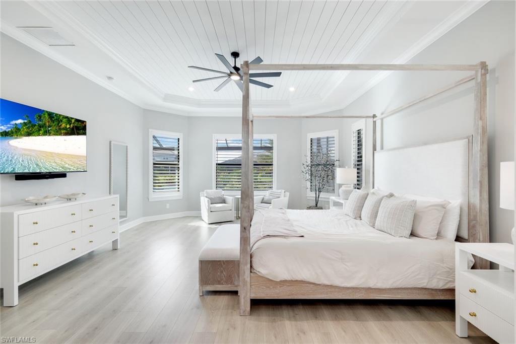 11200 Canal Grande Drive Fort Myers, FL 33913 - Photo 14 of 29 a bedroom with a large bed and a flat tv screen on dresser