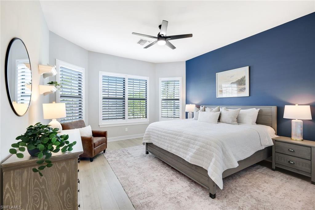 11200 Canal Grande Drive Fort Myers, FL 33913 - Photo 19 of 29 a spacious bedroom with a bed a window and a potted plant