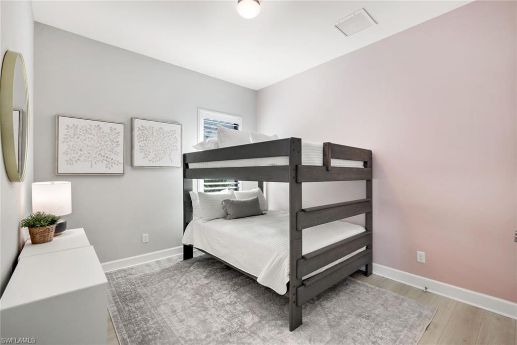 11200 Canal Grande Drive Fort Myers, FL 33913 - Photo 20 of 29 a bedroom with a bed and a night stand