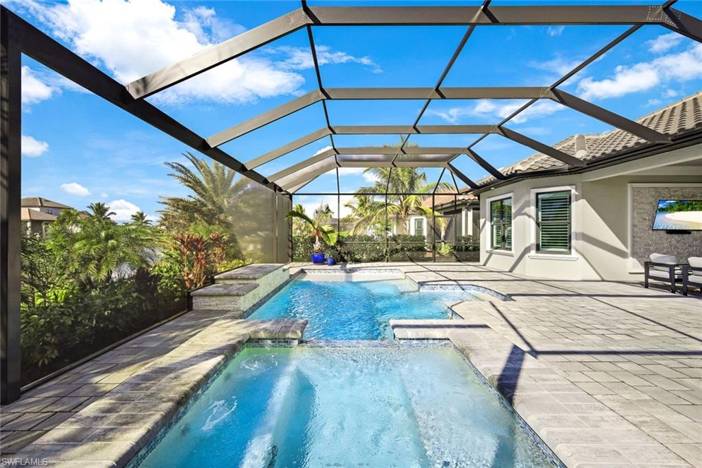 11200 Canal Grande Drive Fort Myers, FL 33913 - Photo 24 of 29 a view of a backyard with table and chairs under an umbrella