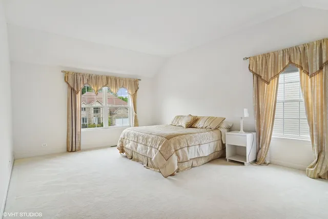 a spacious bedroom with a bed and a window