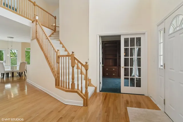 a view of entryway and hall with wooden floor