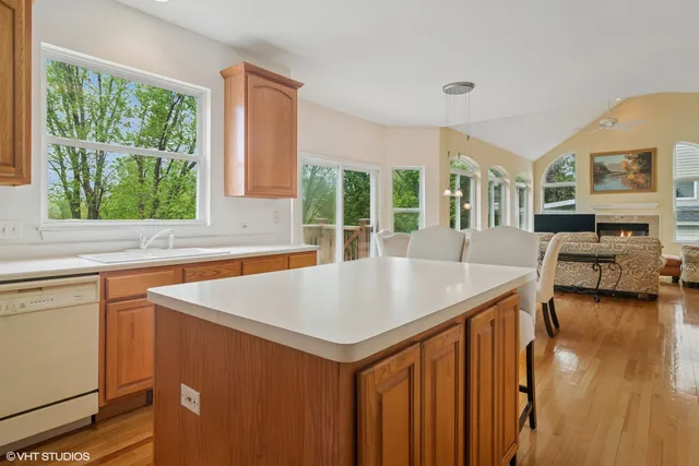 a view of a kitchen counter top space with wooden floor and furniture