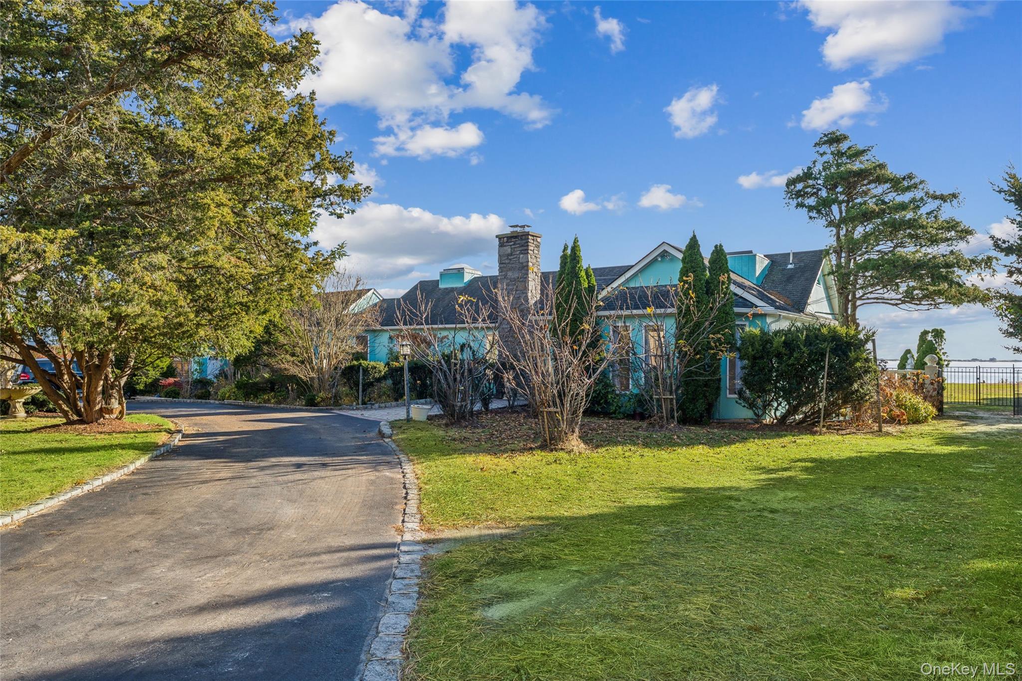 a view of a fountain in front of a house with a big yard