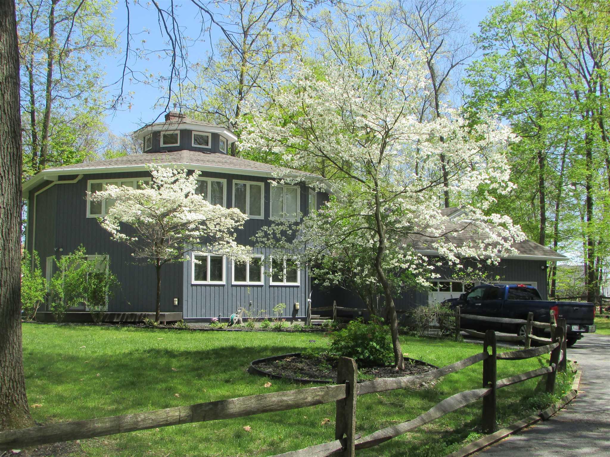 a front view of a house with yard and green space