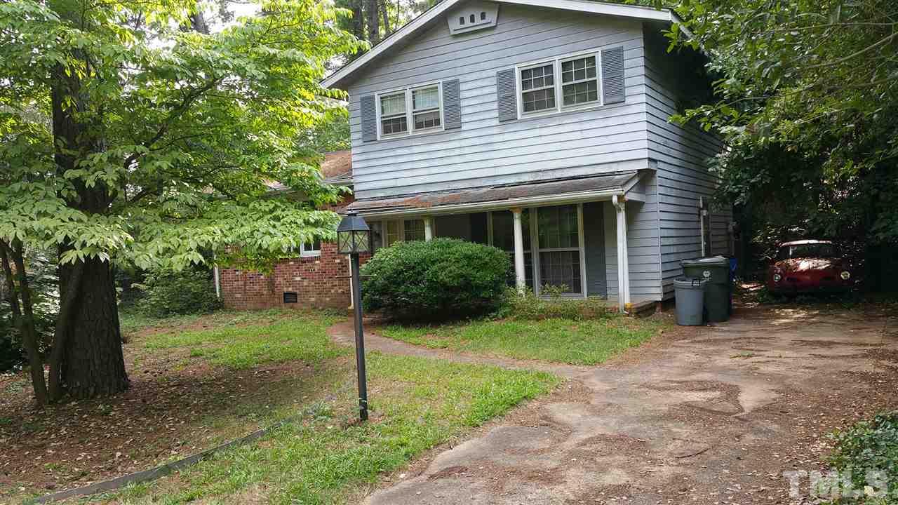 a view of a house with a yard and tree s