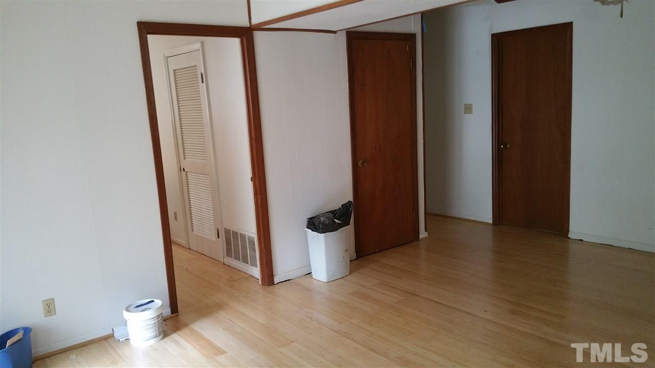 504 Old Farm Road Raleigh, NC 27606 - Photo 5 of 6 an empty room with wooden floor and entrance