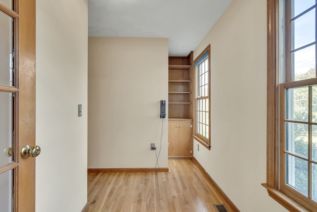 7 Stouffer Circle Andover, MA 01810 - Photo 13 of 37 a view of empty room with windows and wooden floor