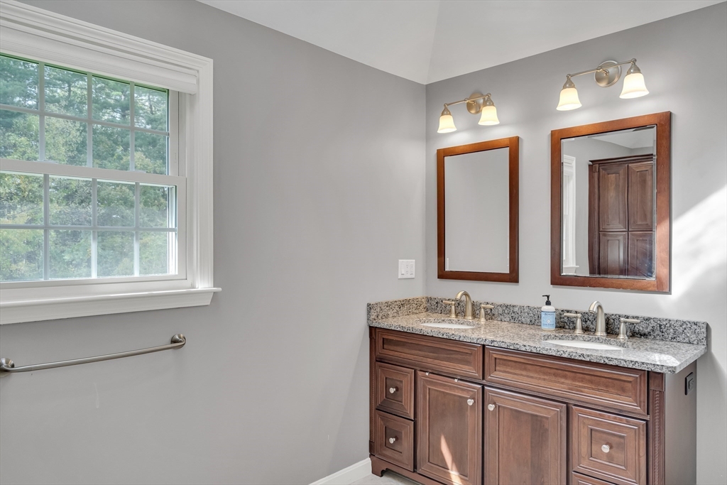 7 Stouffer Circle Andover, MA 01810 - Photo 20 of 37 a bathroom with a granite countertop sink a large mirror a and window
