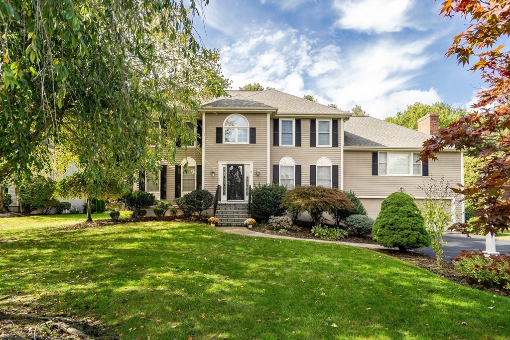 7 Stouffer Circle Andover, MA 01810 - Photo 2 of 37 a front view of a house with a yard table and chairs
