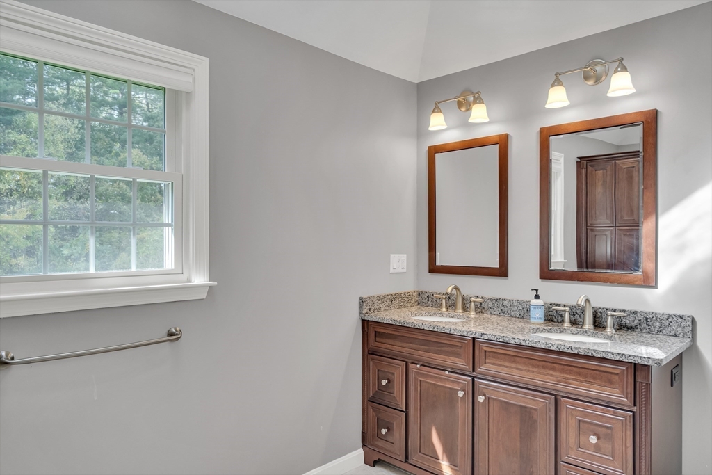 7 Stouffer Circle Andover, MA 01810 - Photo 24 of 37 a bathroom with a granite countertop sink a large mirror a and window