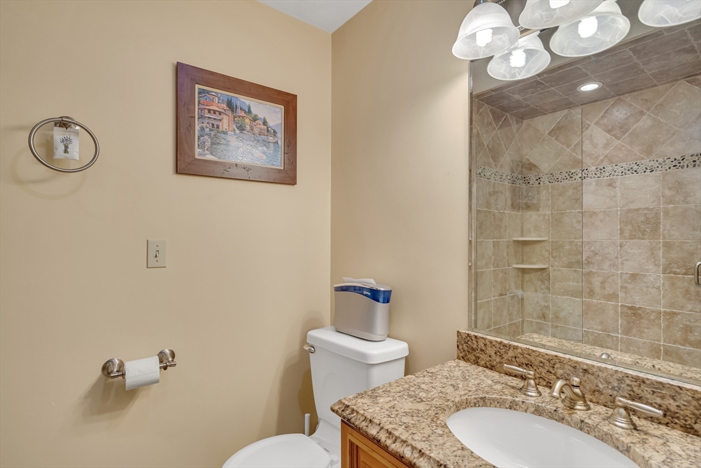7 Stouffer Circle Andover, MA 01810 - Photo 27 of 37 a bathroom with a granite countertop toilet sink and mirror