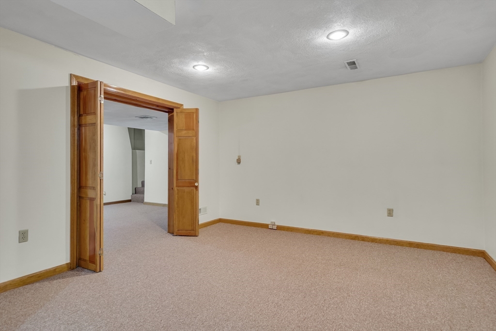 7 Stouffer Circle Andover, MA 01810 - Photo 28 of 37 an empty room with wooden floor and windows