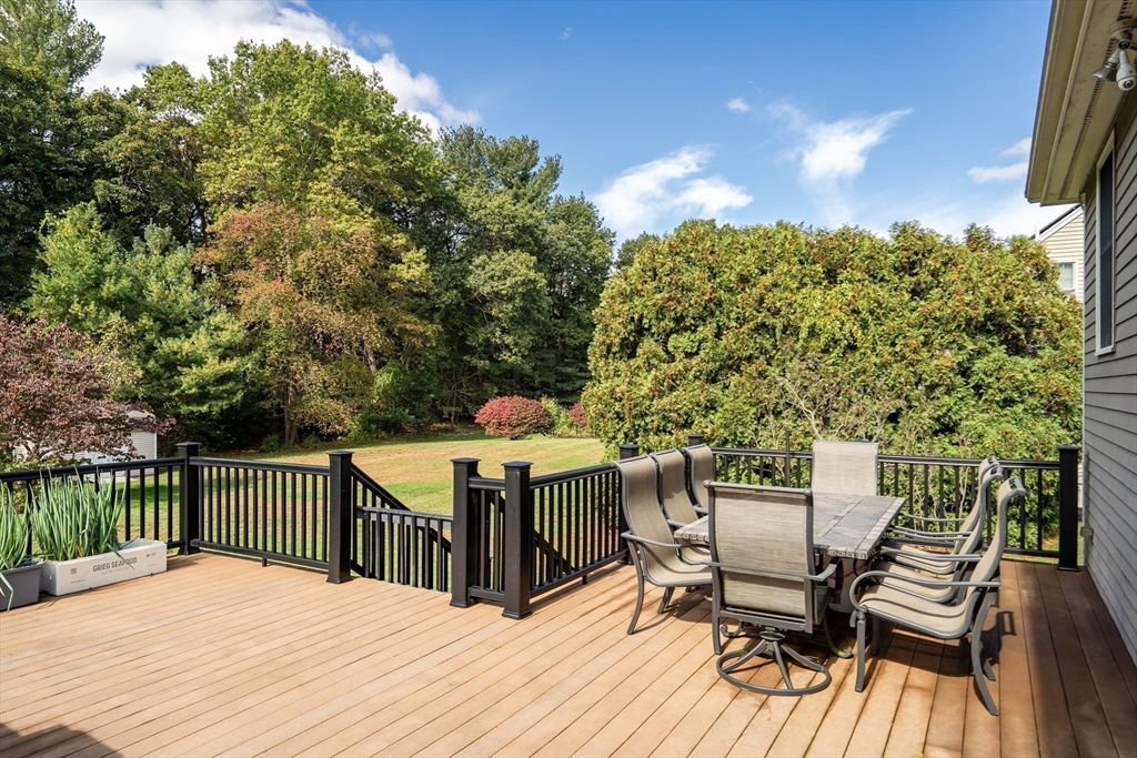 7 Stouffer Circle Andover, MA 01810 - Photo 30 of 37 a view of a patio with table and chairs with wooden floor and fence