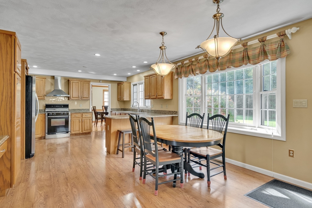 7 Stouffer Circle Andover, MA 01810 - Photo 6 of 37 a dining room with furniture a chandelier and wooden floor