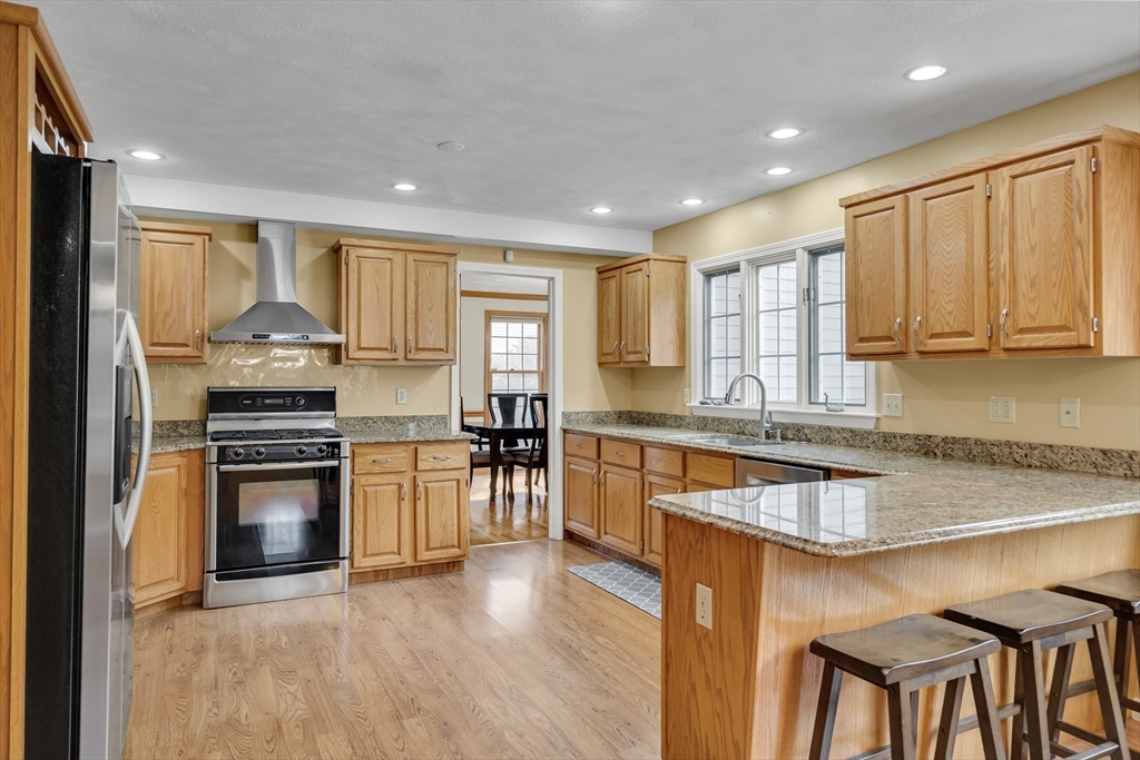 7 Stouffer Circle Andover, MA 01810 - Photo 8 of 37 a kitchen with granite countertop counter top space a sink stainless steel appliances and cabinets