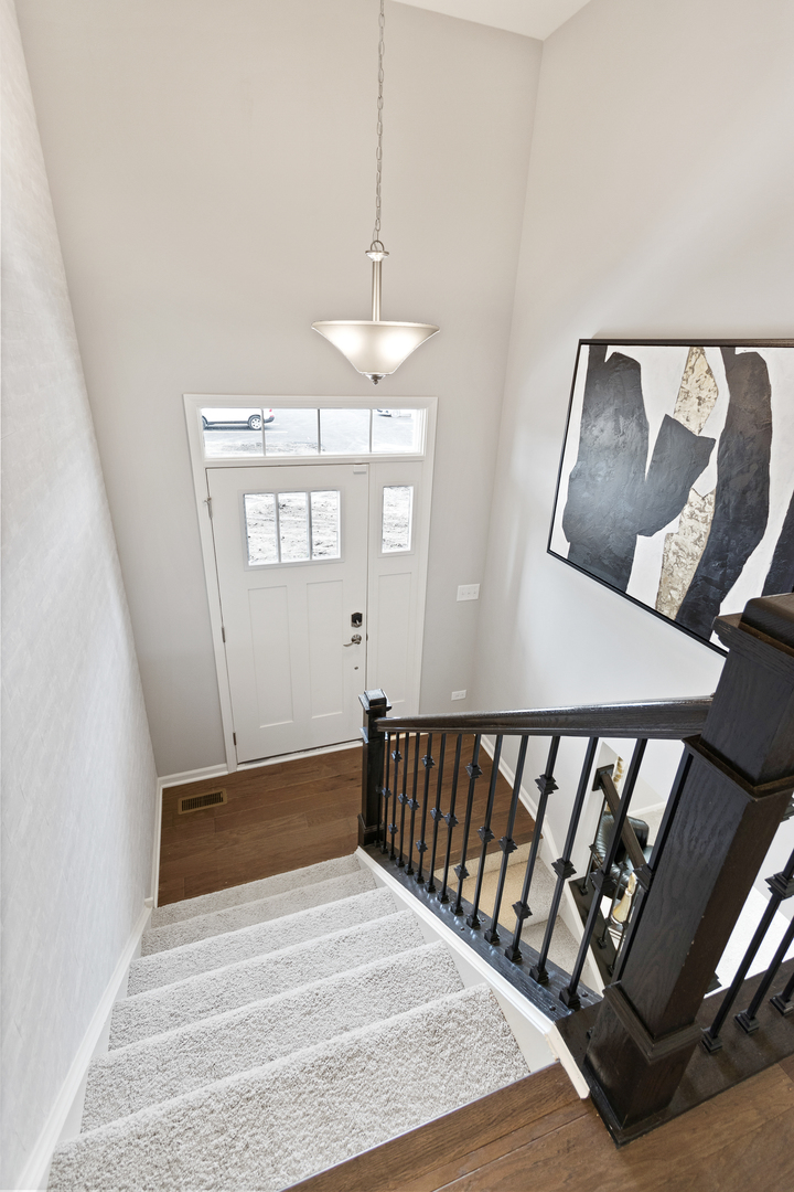 1654 BENTZ Way Batavia, IL 60510 - Photo 3 of 27 a view of a hallway with wooden floor and staircase