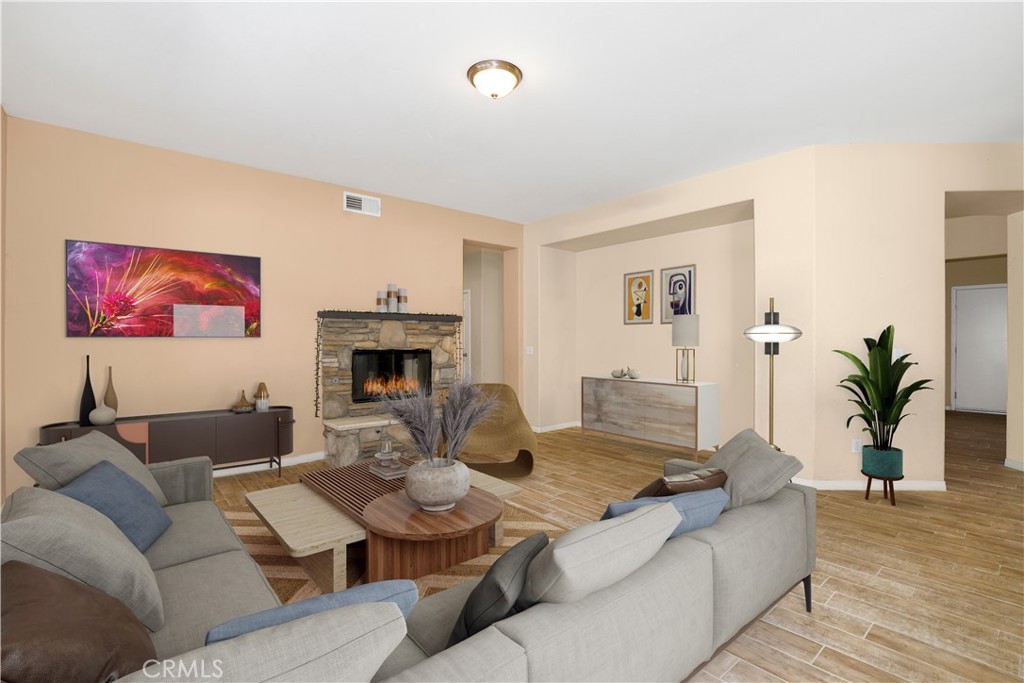 3437 Nature Trail Court Perris, CA 92571 - Photo 13 of 49 a living room with furniture kitchen view and a fireplace
