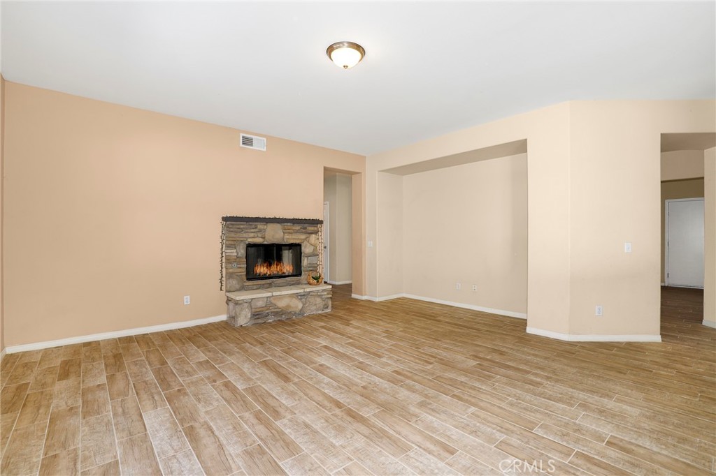 3437 Nature Trail Court Perris, CA 92571 - Photo 14 of 49 a view of empty room with wooden floor and fireplace