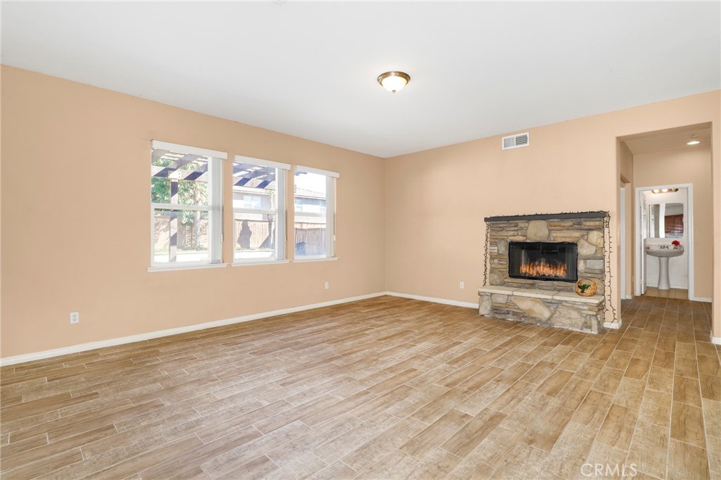 3437 Nature Trail Court Perris, CA 92571 - Photo 15 of 49 wooden floor fireplace and windows in an empty room
