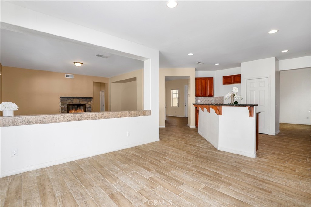 3437 Nature Trail Court Perris, CA 92571 - Photo 16 of 49 a large kitchen with stainless steel appliances kitchen island a large counter top and a wooden floors
