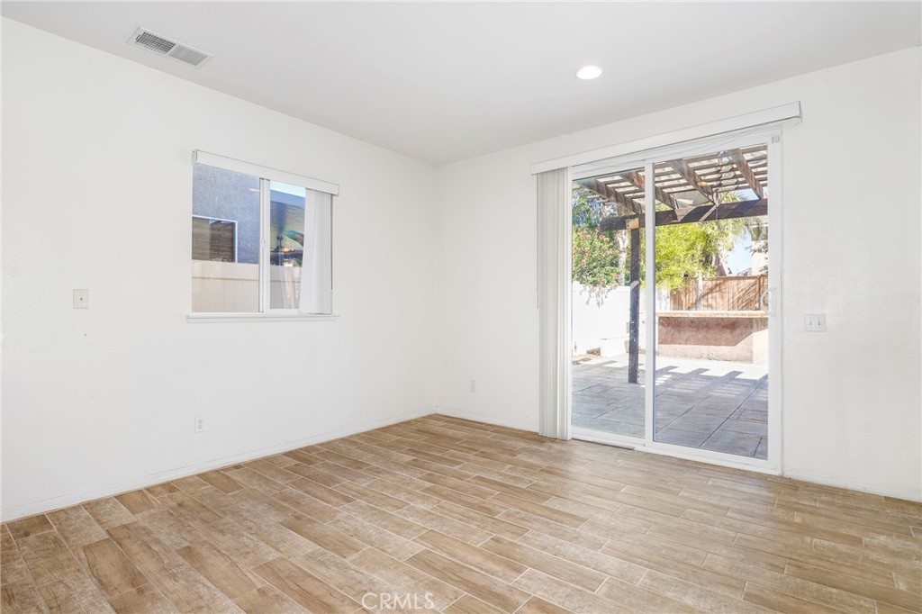 3437 Nature Trail Court Perris, CA 92571 - Photo 18 of 49 an empty room with wooden floor and a window