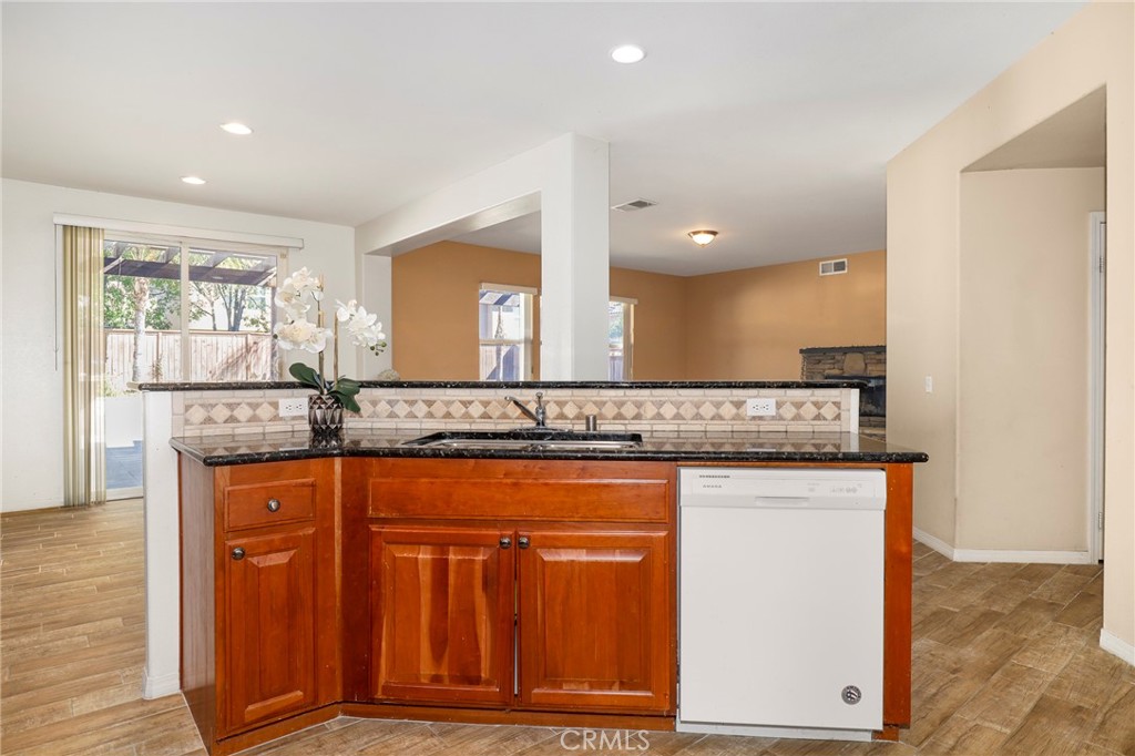 3437 Nature Trail Court Perris, CA 92571 - Photo 19 of 49 a bathroom with a granite countertop sink a mirror and a shower