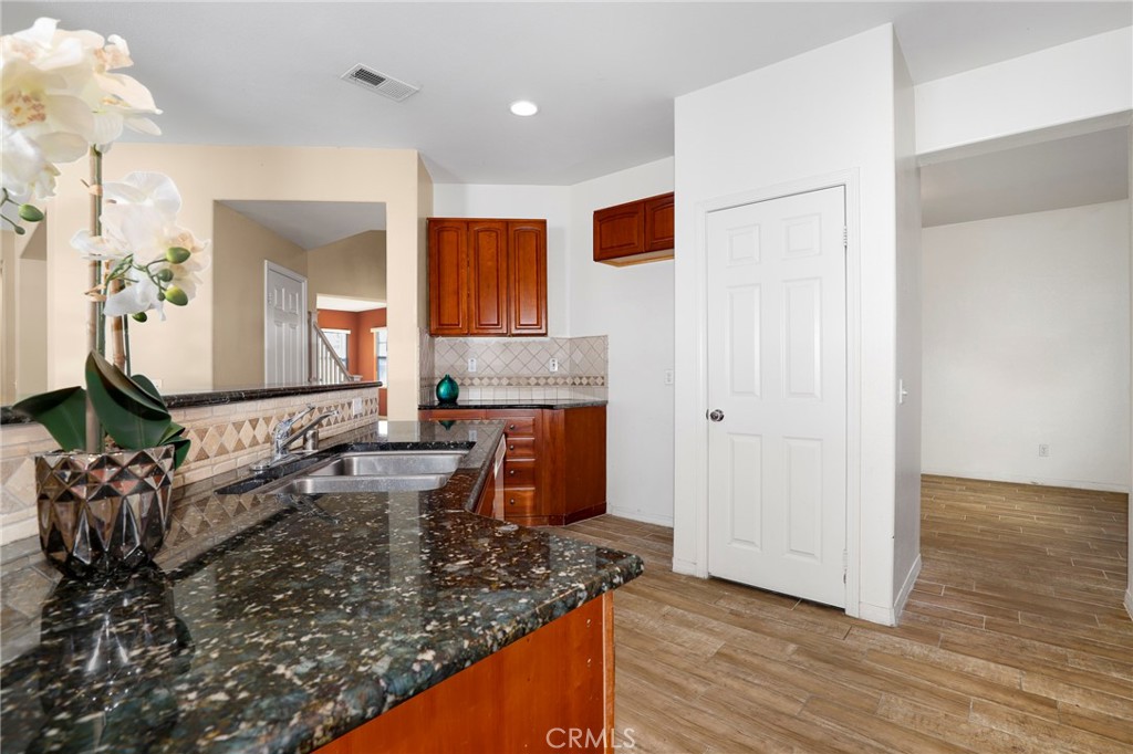 3437 Nature Trail Court Perris, CA 92571 - Photo 22 of 49 a kitchen with stainless steel appliances granite countertop a sink and a granite counter tops