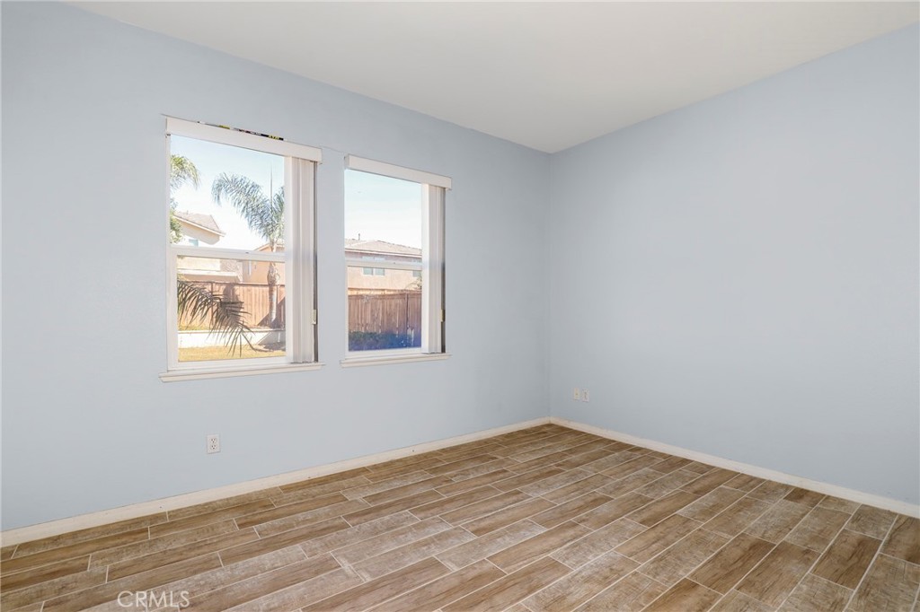 3437 Nature Trail Court Perris, CA 92571 - Photo 24 of 49 a view of an empty room with wooden floor and a window