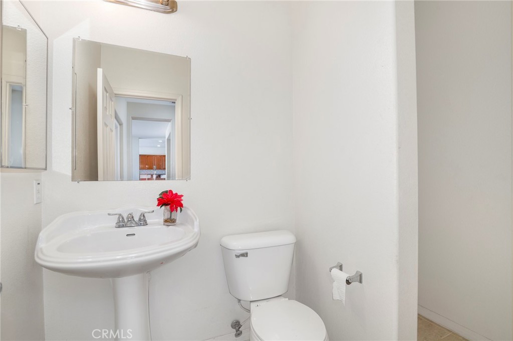 3437 Nature Trail Court Perris, CA 92571 - Photo 26 of 49 a bathroom with a sink and a toilet