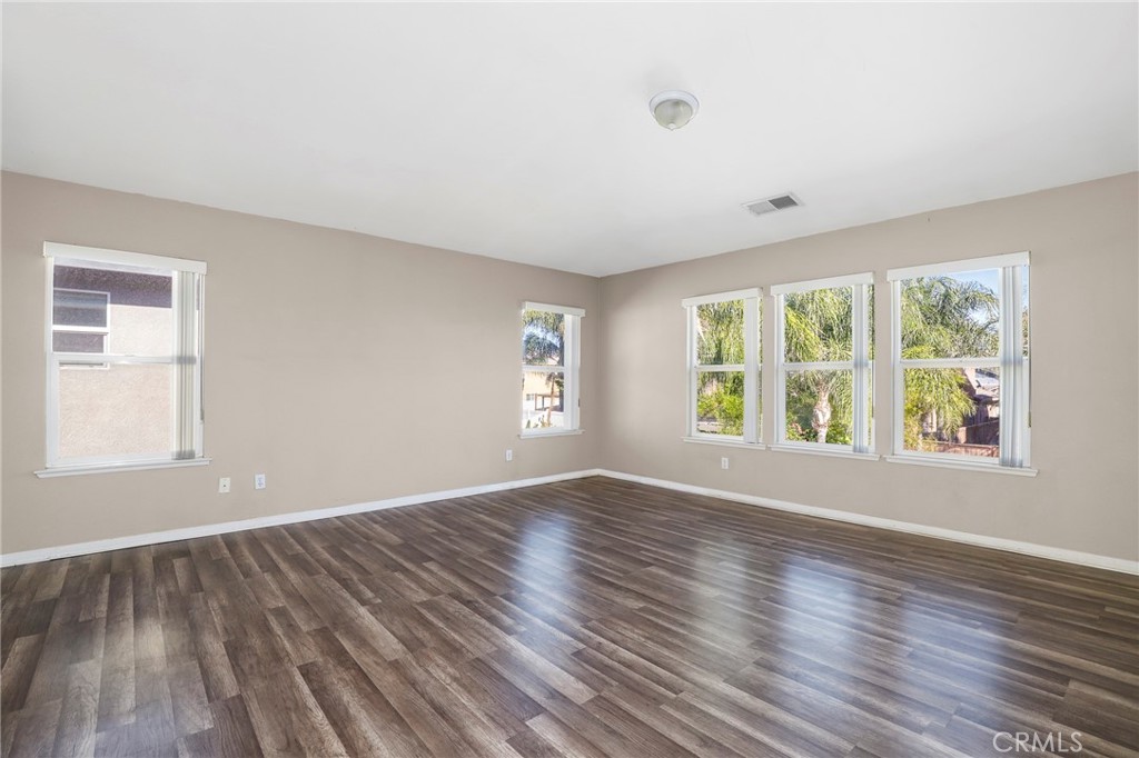 3437 Nature Trail Court Perris, CA 92571 - Photo 32 of 49 an empty room with wooden floor and windows