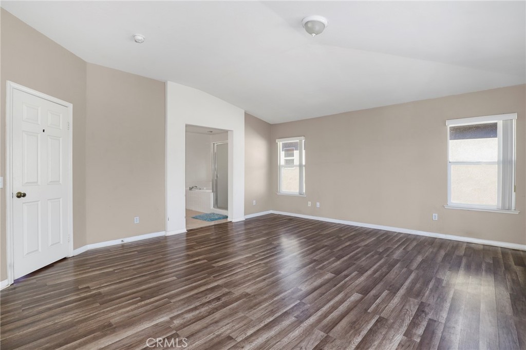 3437 Nature Trail Court Perris, CA 92571 - Photo 33 of 49 a view of an empty room with wooden floor and a window