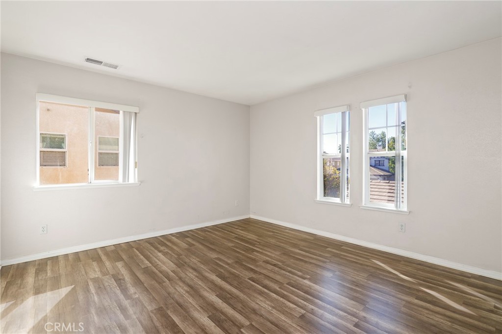 3437 Nature Trail Court Perris, CA 92571 - Photo 35 of 49 a view of an empty room with wooden floor and a window