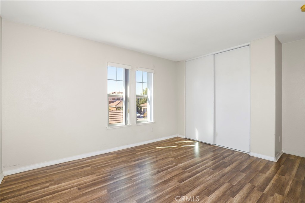 3437 Nature Trail Court Perris, CA 92571 - Photo 36 of 49 a view of a room with wooden floor and windows in a room